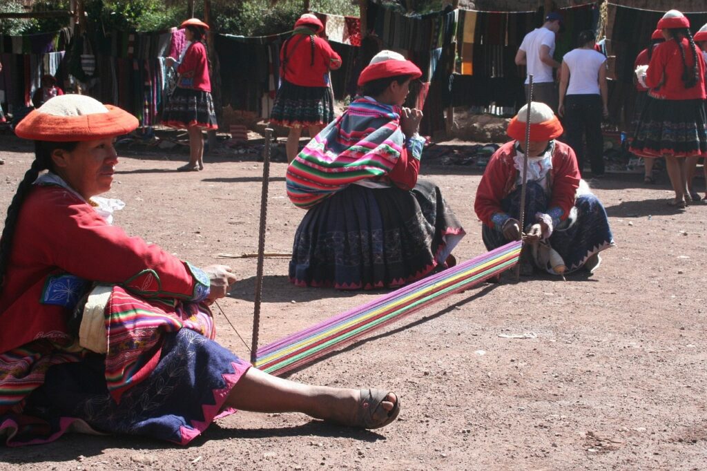 Women demonstrate traditional weaving in peru social enteprise